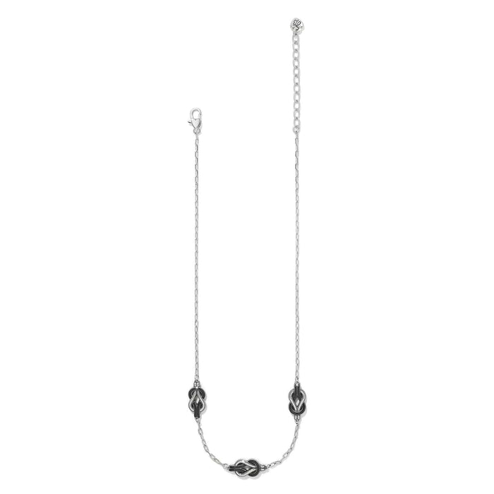 Brighton silver-plated necklace with three knot stations featuring black enamel accents and lobster clasp on a white background