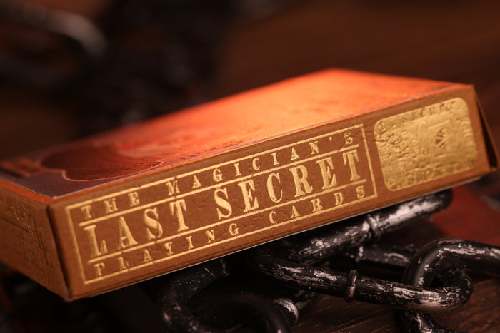 Hearts edition tuck box of 'The Magician's Last Secret Playing Cards' with gold hot foil text on a dark background