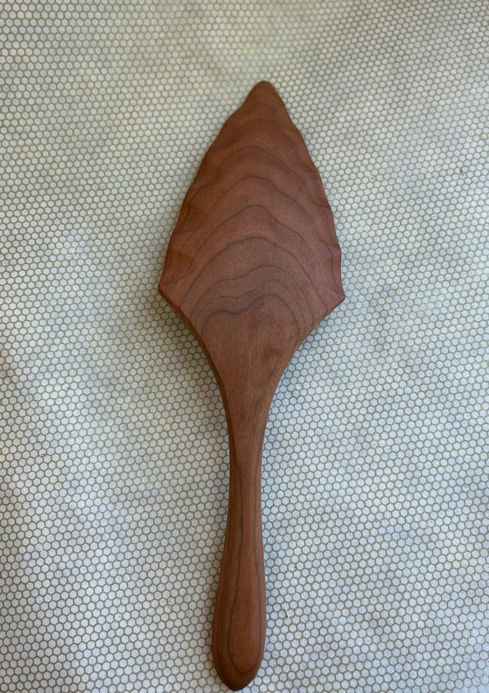 Jonathan's Spoons natural wooden pie server on light natural background.