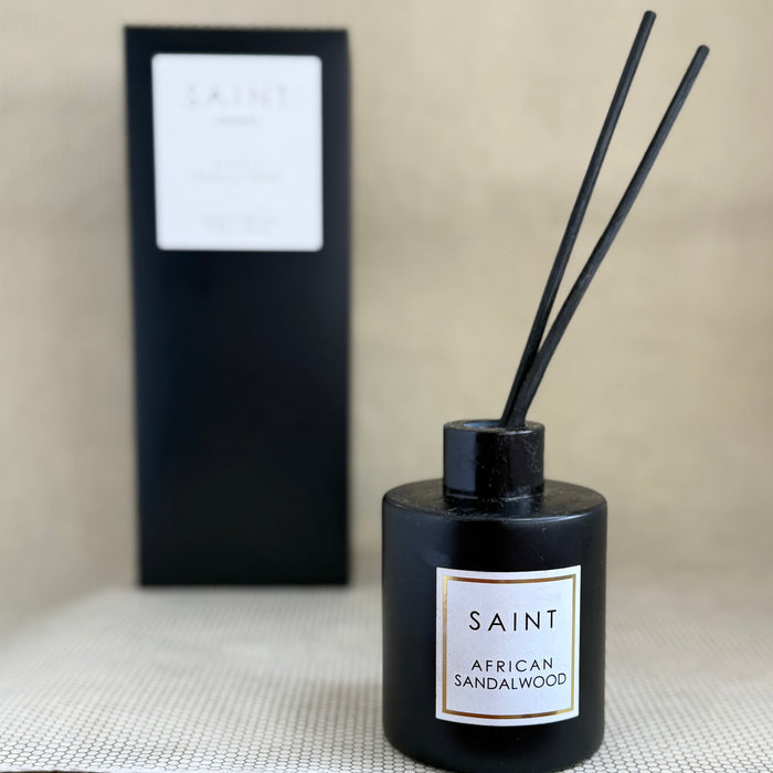 black reed diffuser bottle and black box. black diffuser wooden reed sticks. SAINT. african sandalwood. 5oz (145mL)