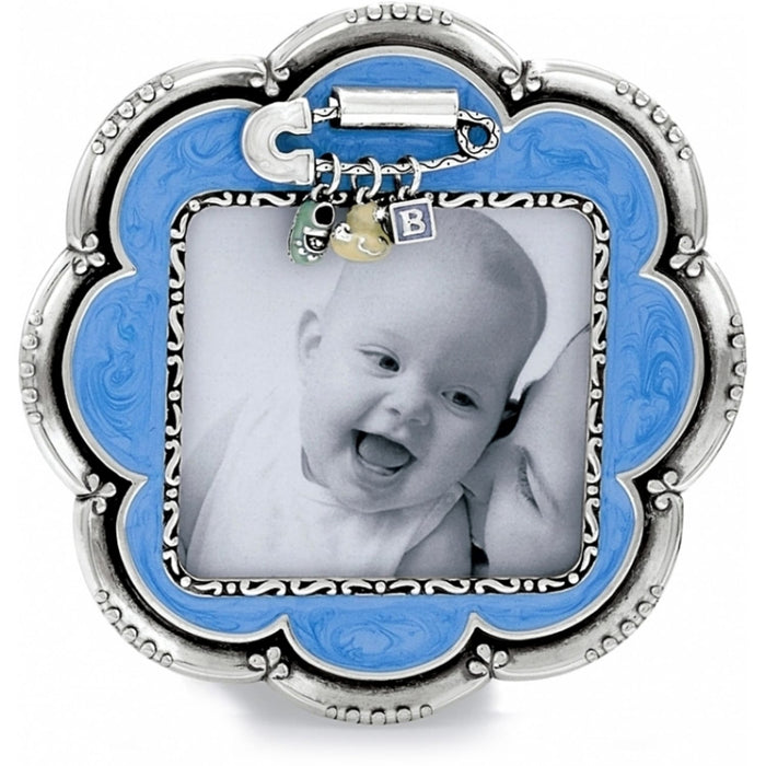 Brighton scalloped photo frame with blue enamel border, silver-tone scroll detailing, and dangling baby charms on a white background