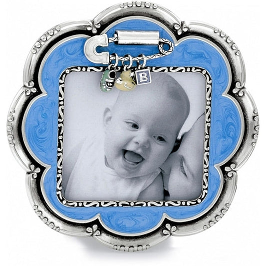 Brighton scalloped photo frame with blue enamel border, silver-tone scroll detailing, and dangling baby charms on a white background