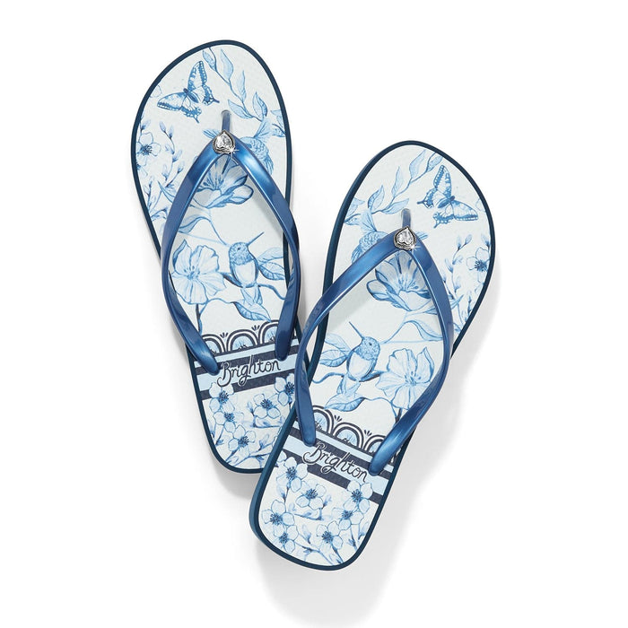 Brighton rubber flip-flop sandals with blue floral and butterfly print and metallic blue straps on a white background
