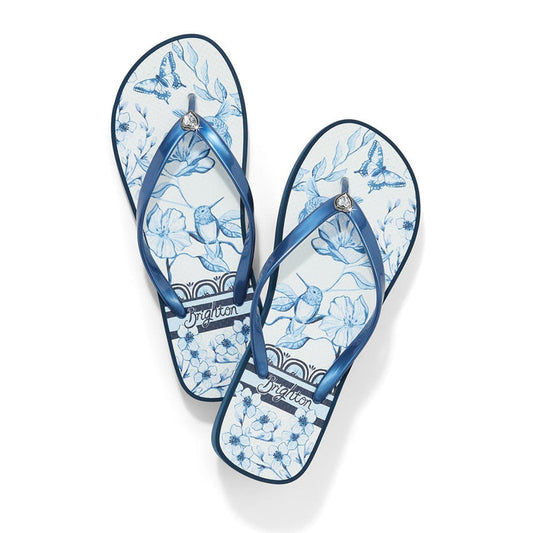Brighton rubber flip-flop sandals with blue floral and butterfly print and metallic blue straps on a white background
