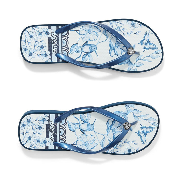 Brighton flip flop sandals with blue floral hummingbird print, metallic blue rubber straps, and heart charm on a white background