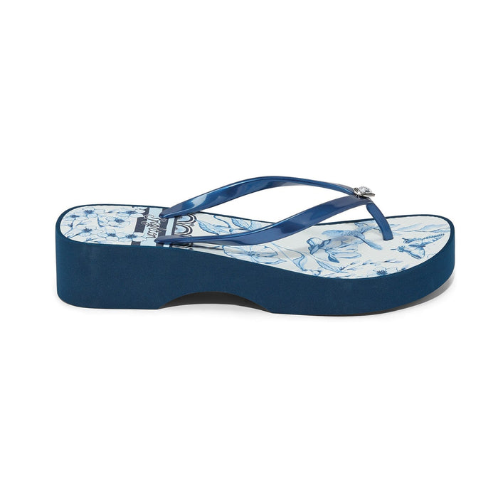 Brighton wedge flip-flop sandal with navy rubber strap and floral printed footbed shown in side view on a white background