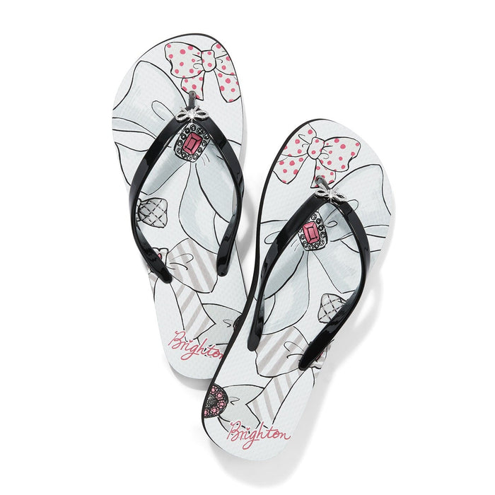 Brighton rubber flip-flop sandals with bow print, black straps, and pink crystal jewel embellishment on a white background