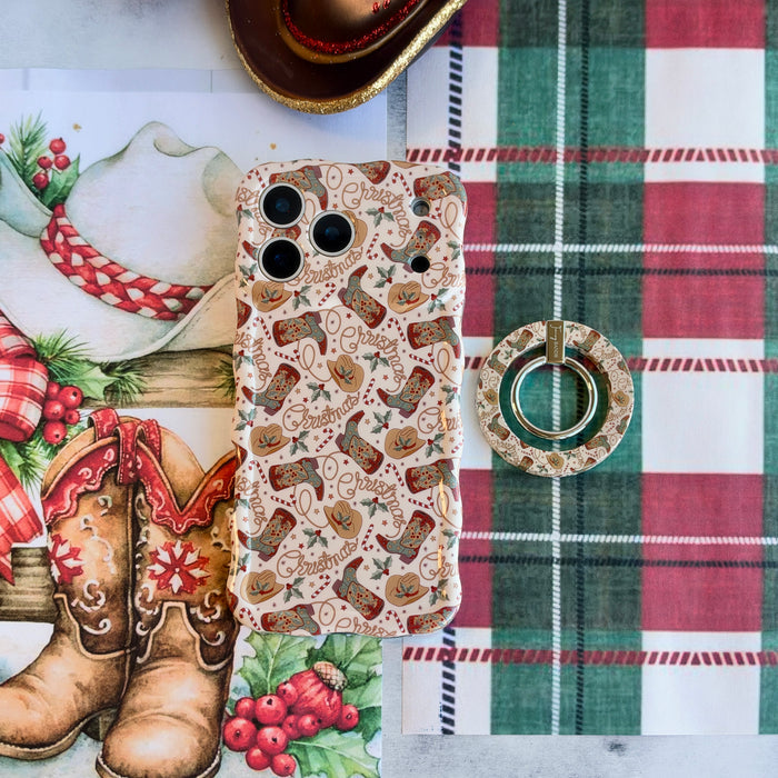 Boot Scootin' Christmas MagSafe grip ring lying beside the matching iPhone case on red and green plaid with watercolor cowboy boots