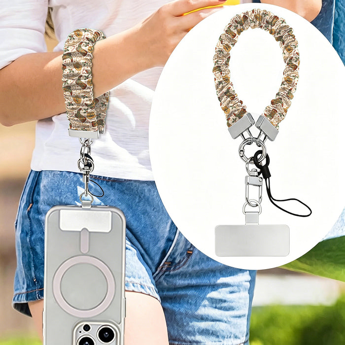 Boot Scootin' Christmas scrunchie phone strap worn on the wrist with an iPhone hanging from it, plus close-up of the strap and phone tab