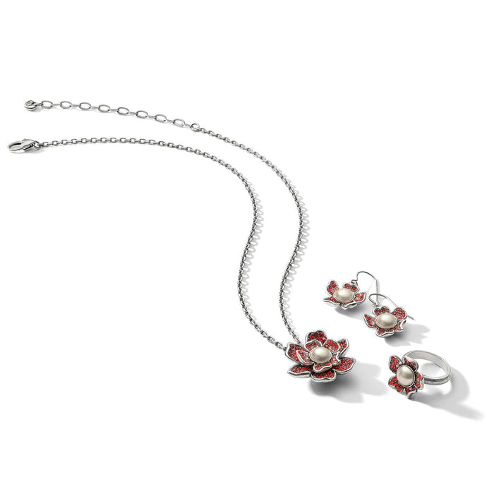 Brighton silver-plated floral jewelry set with red crystals and glass pearl cabochons including necklace, earrings, and ring on a white background