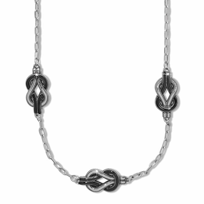 Brighton necklace with three silver-plated knot stations and black enamel detailing on a chain on a white background
