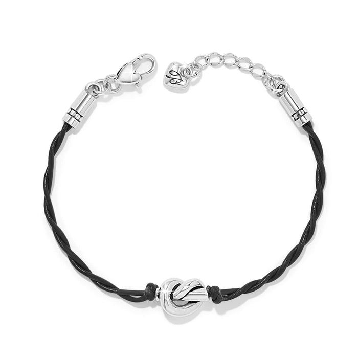 Brighton bracelet with twisted black leather cord, silver-plated knot centerpiece, lobster clasp, and heart charm on a white background