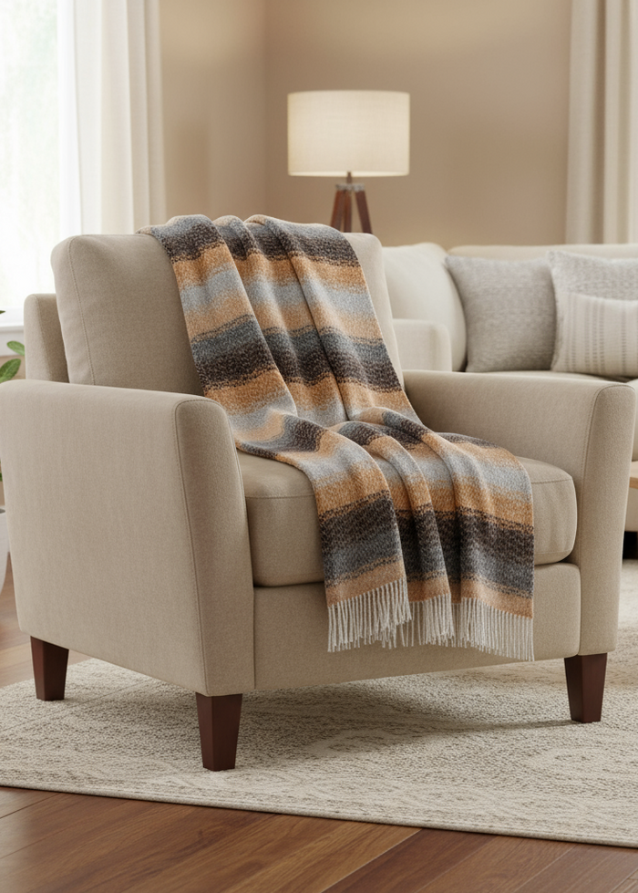 Beige armchair with a plaid blanket in a living room setting