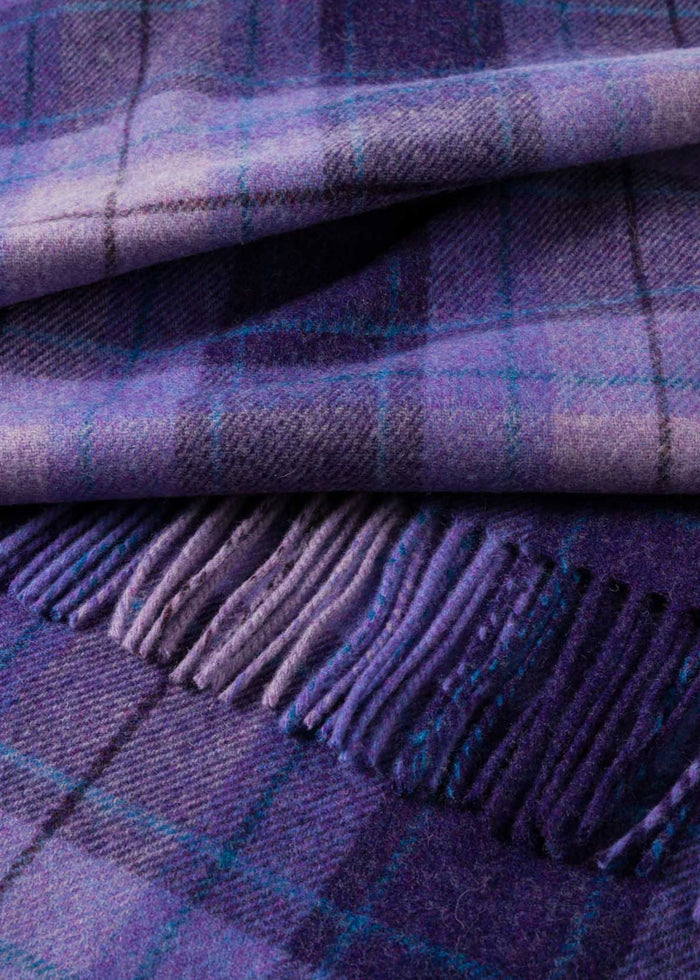 Close-up of a purple plaid fabric with fringes