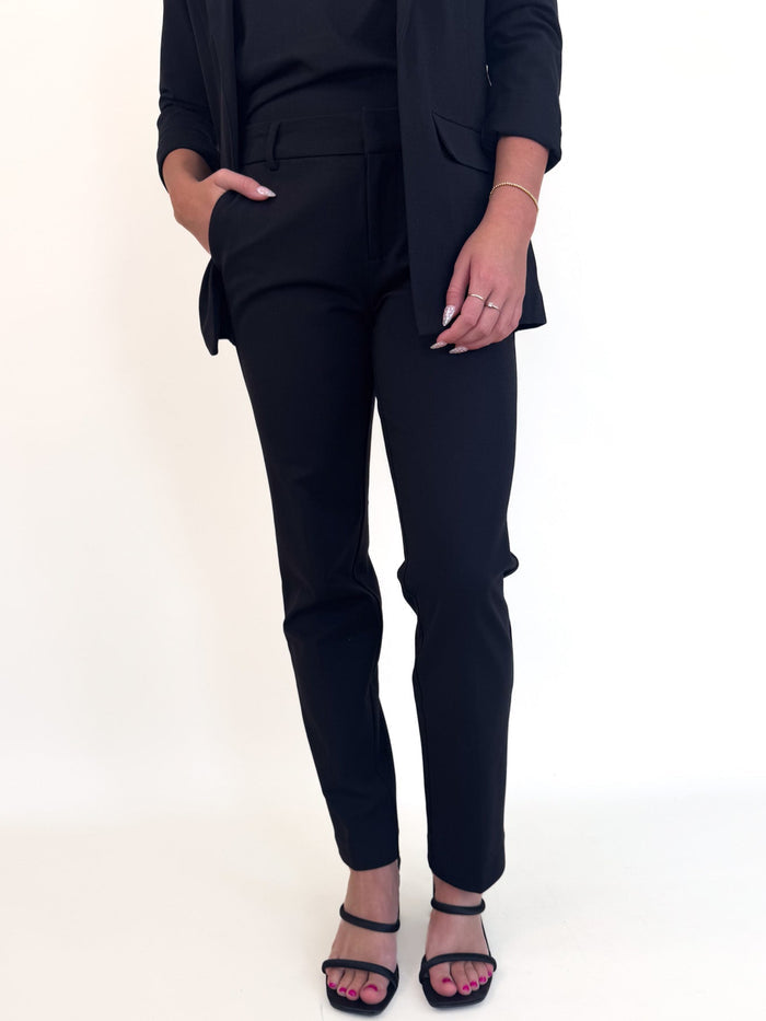 Person wearing a black suit on a white background