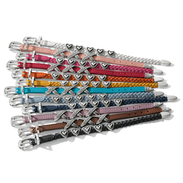 Brighton braided leather belts in assorted colors with silver-plated heart accents and buckles on a white background