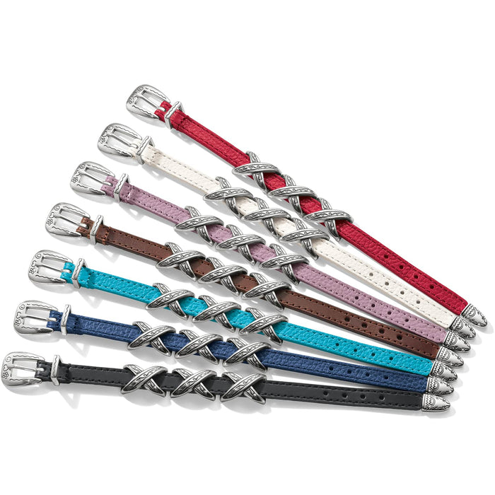 Brighton leather bracelets in seven colors with silver-plated buckles and engraved X-shaped accents on a white background