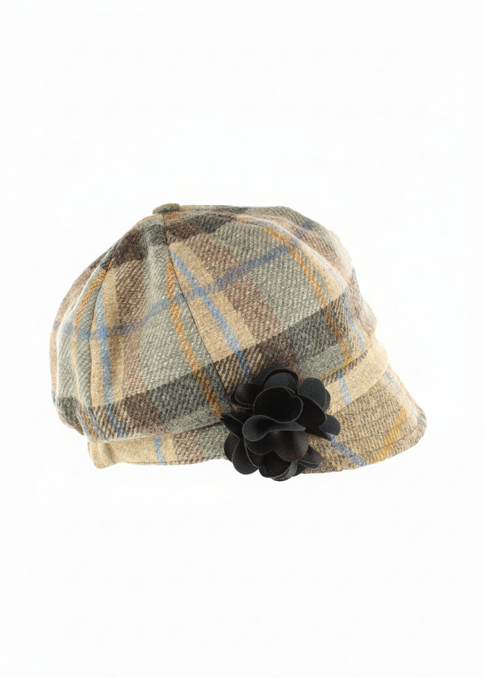 Plaid patterned hat with a black flower on a white background