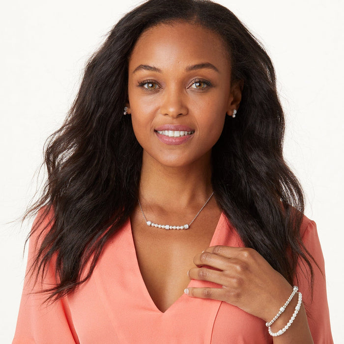 Model wearing a Brighton silver-plated pearl necklace with crystal accents paired with matching pearl stud earrings