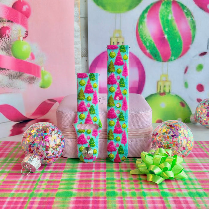 Both straps of the Merry & Bright, Totally! silicone Samsung Galaxy Watch band on a pink jewelry box with confetti ornaments and a lime bow
