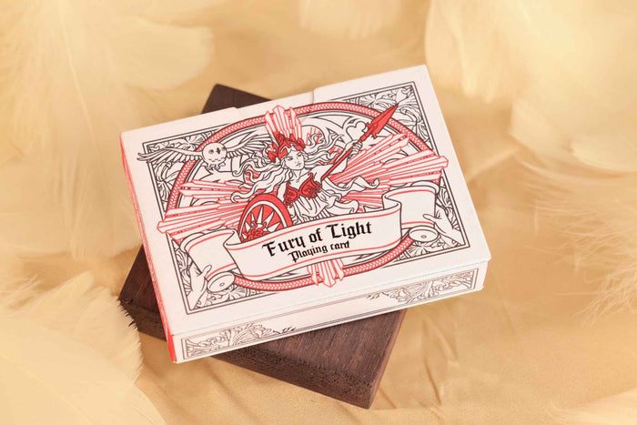 MYTHIC edition Fury of Light Tuck Box with an illustration of a goddess on a bed of feathers.