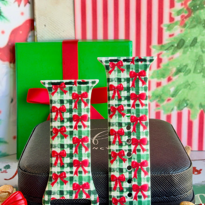 Close-up of both Plaid Tidings & Bows Apple Watch band straps with red bows on green and white gingham
