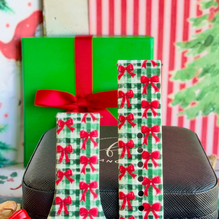 Close-up of both Plaid Tidings & Bows Samsung Galaxy Watch band straps with red bows on green gingham