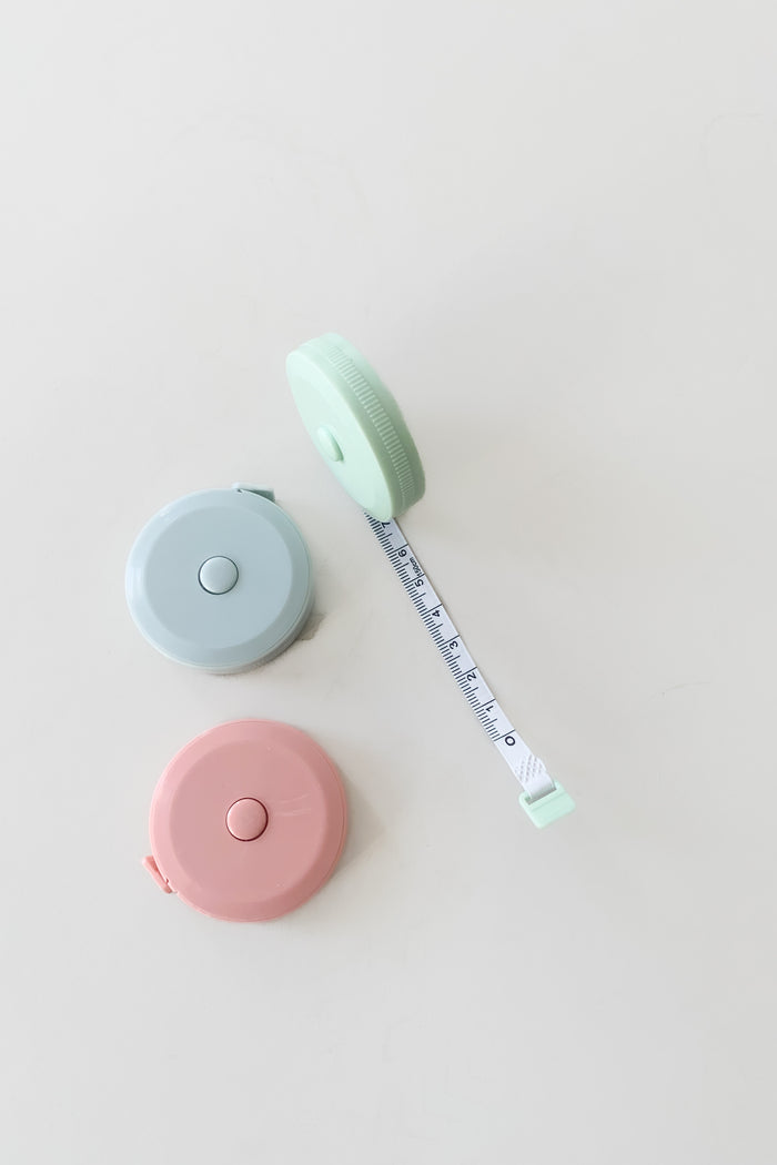 Super cute and handy 60 inch or 150cm pocket tape measure with retractable button. These are great for gifts or stocking stuffers and come in three colors. They are $2.99 each.