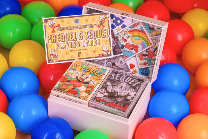 Prequel and Sequel Playing cards in the Collector's Box with colorful packaging on a bed of multicolored balls