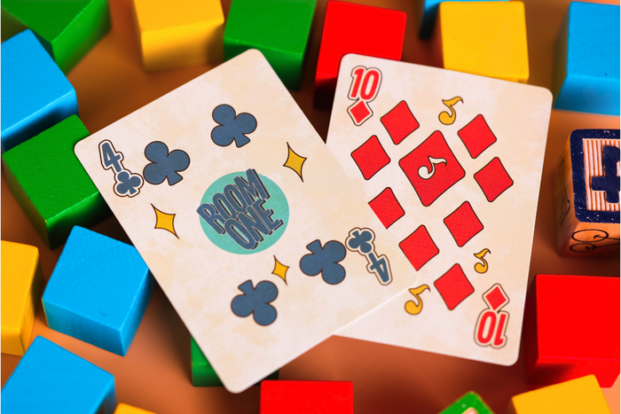 Two number cards surrounded by colorful building blocks on a wooden surface
