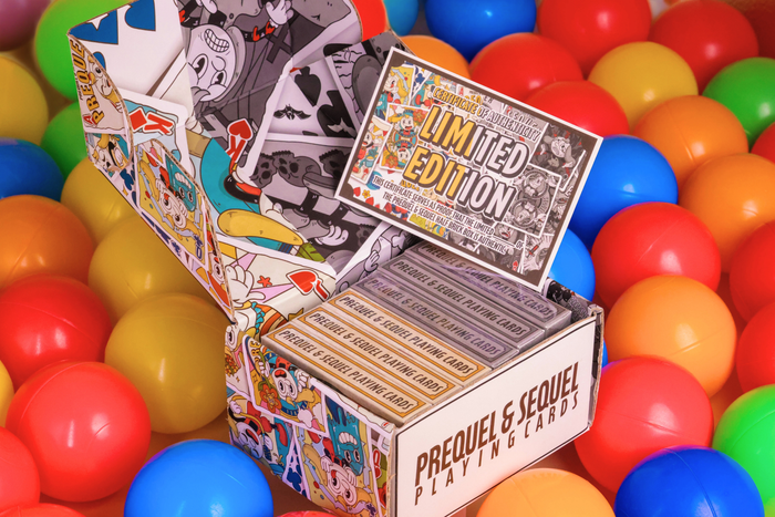 Open box of Prequel & Sequel playing cards surrounded by colorful balls