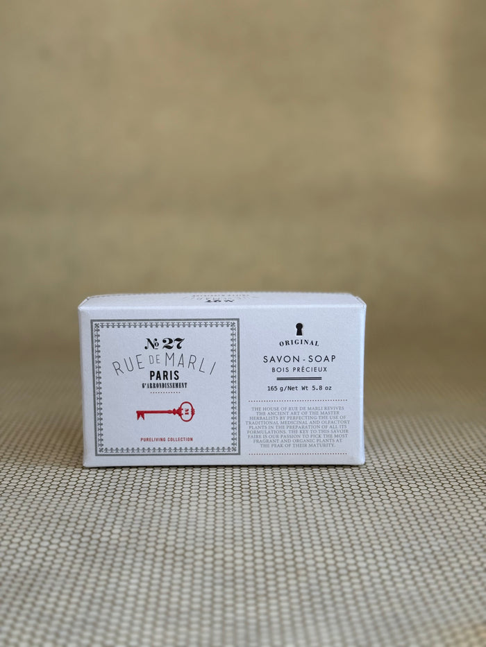 rue de marli bar soap in white package on neutral background.