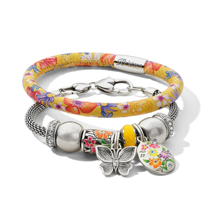 Brighton bracelet set with yellow floral print band and silver-plated charm bracelet featuring butterfly and crystal accents on a white background