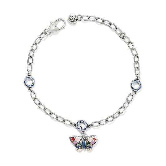 Brighton charm bracelet with silver-plated chain, enamel flower stations, and butterfly charm with floral enamel detail on a white background