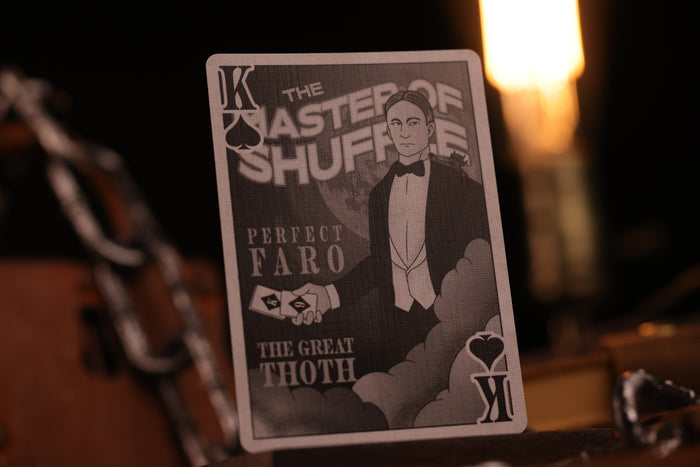 Playing card with a magician and text on a dark background