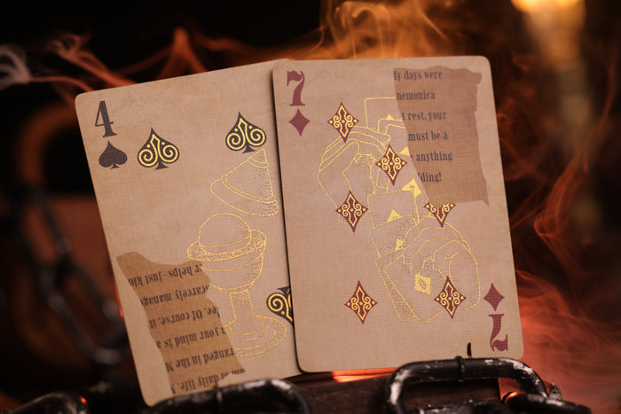 Two number cards with metallic gold cold foil detailing on a dark background