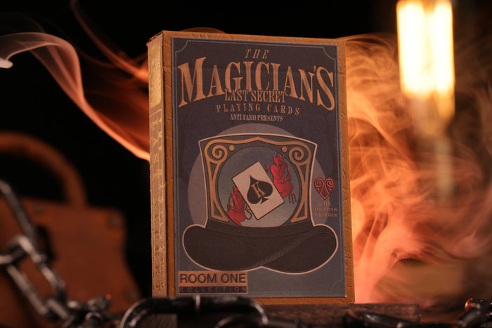 Hearts Edition tuck box labeled with 'The Magician's Last Secret' with a top hat and card design, surrounded by smoke and light.