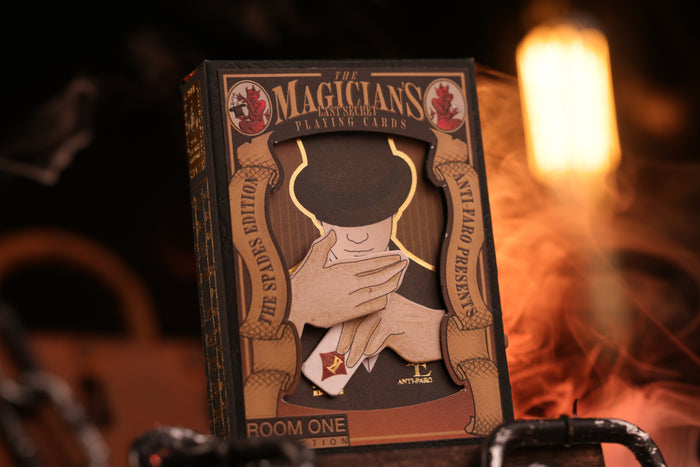 Spades Edition tuck box with 'The Magician's' branding against a warm, blurred background