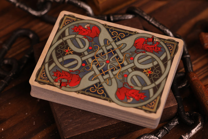 Hearts Edition playing card backs with intricate designs on a wooden surface