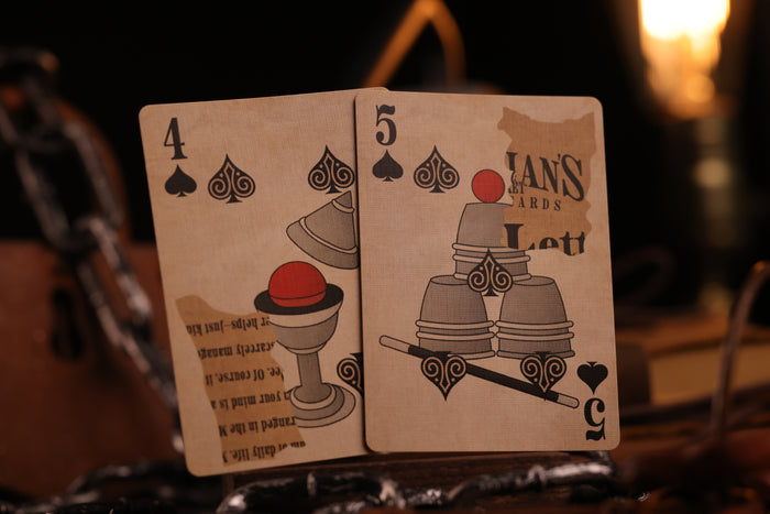 Two Number cards with intricate designs and text on a dark background