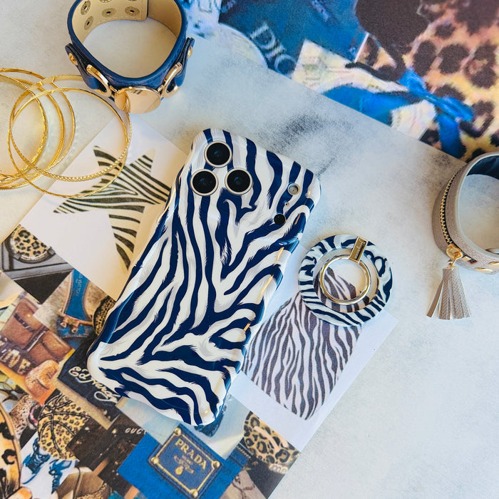 Zebra, Obviously navy zebra print MagSafe grip ring shown beside the matching zebra iPhone case on an animal-print fashion flat lay with a tassel keyring and gold hoops.